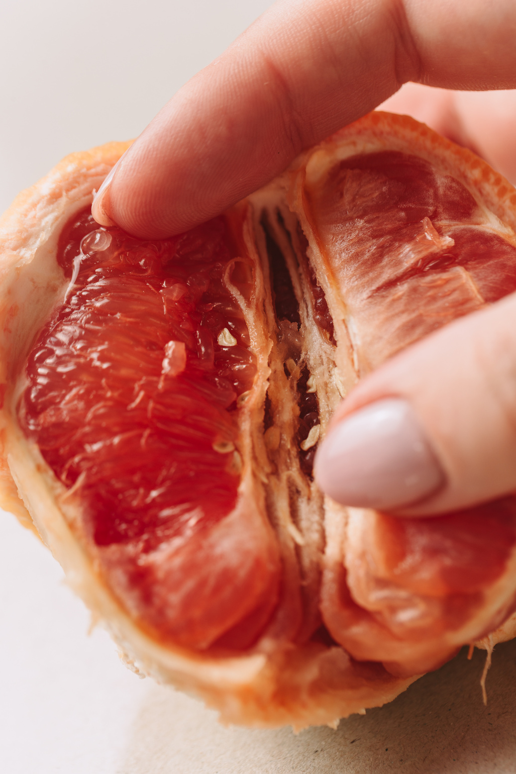 Finger Pressing on Grapefruit